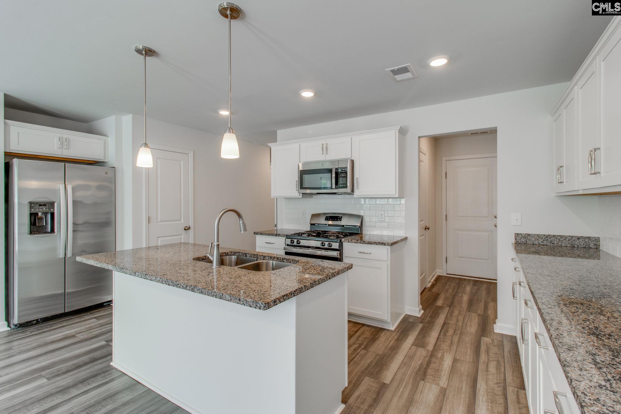 312 Reedmace Court Lexington, SC 29072 - Photo 11 of 29 a kitchen with sink refrigerator and microwave