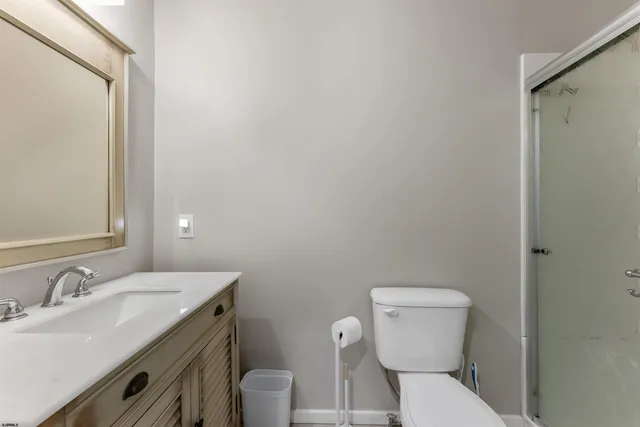 a bathroom with a toilet a sink and mirror