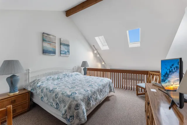 a bedroom with a bed a couch and dresser