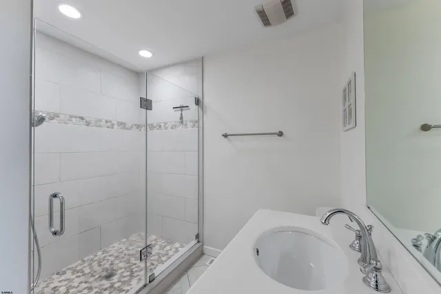 a bathroom with a sink and shower