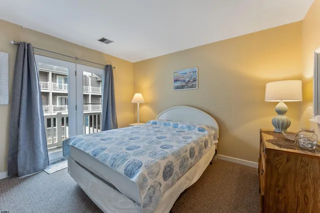 a bed sitting in a bedroom next to a lamp