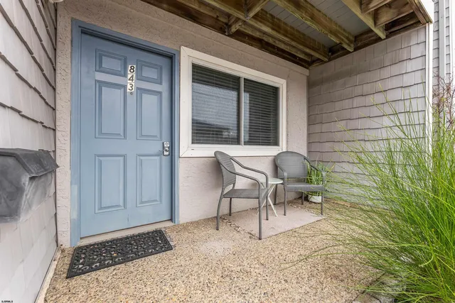 a view of a door and chair in front of a house