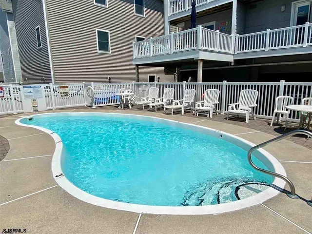 a view of a house with a swimming pool and porch