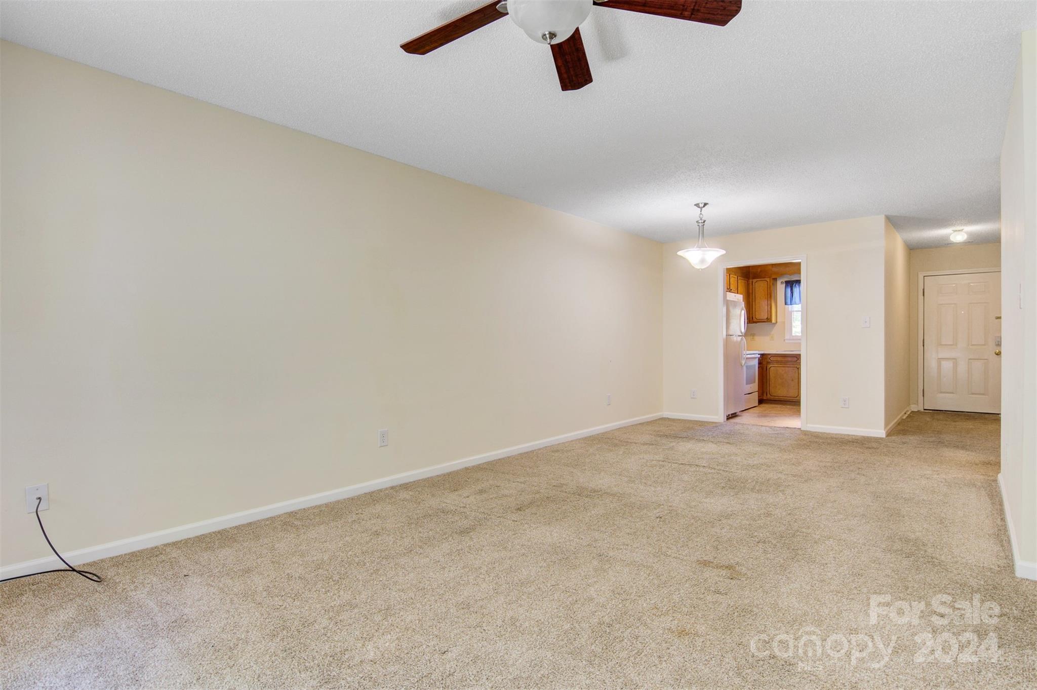 1318 5th Street Northeast Hickory, NC 28601 - Photo 11 of 27 an empty room with a empty space and a ceiling fan