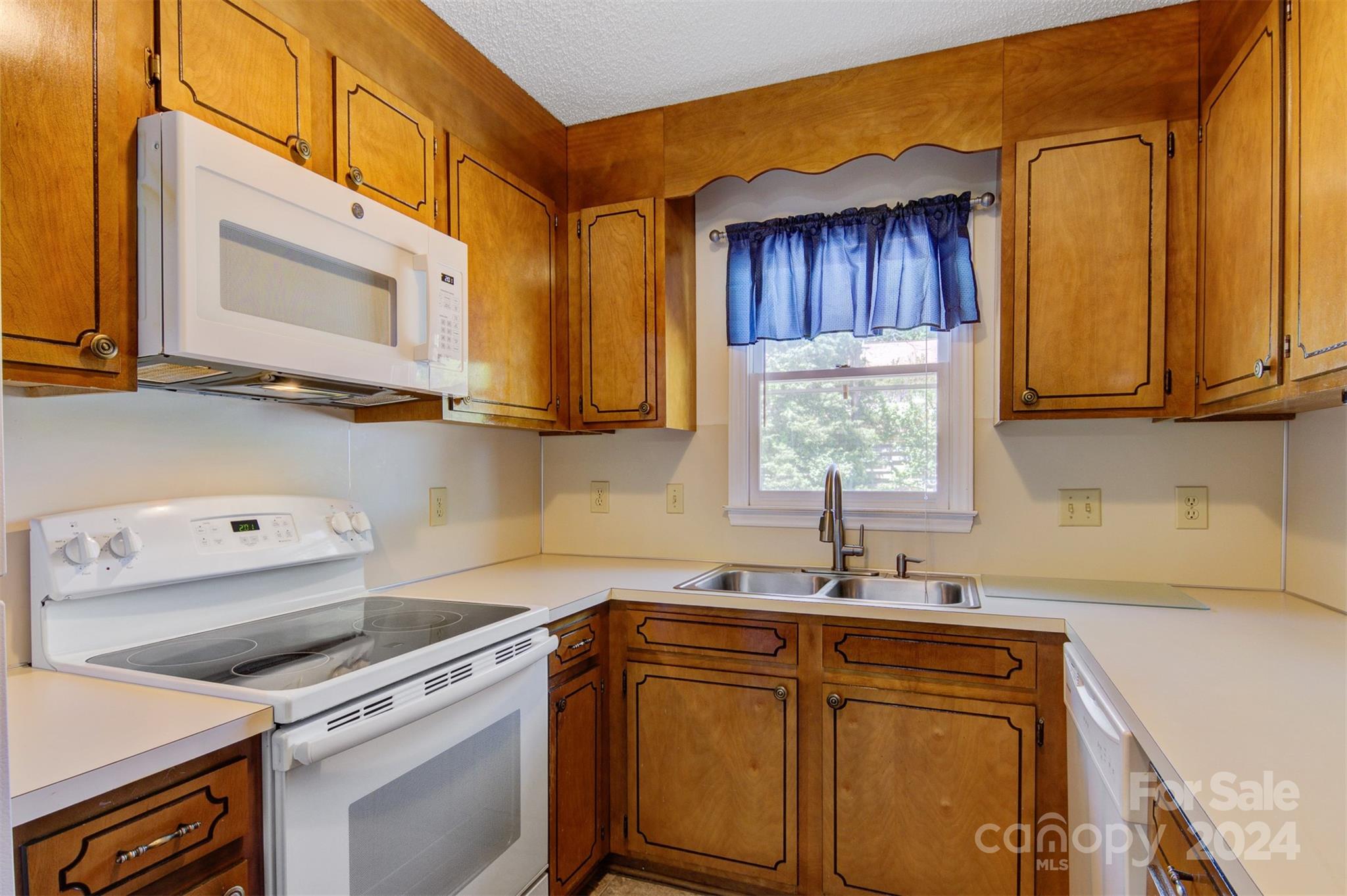 1318 5th Street Northeast Hickory, NC 28601 - Photo 14 of 27 a kitchen with stainless steel appliances granite countertop a sink a stove and cabinets