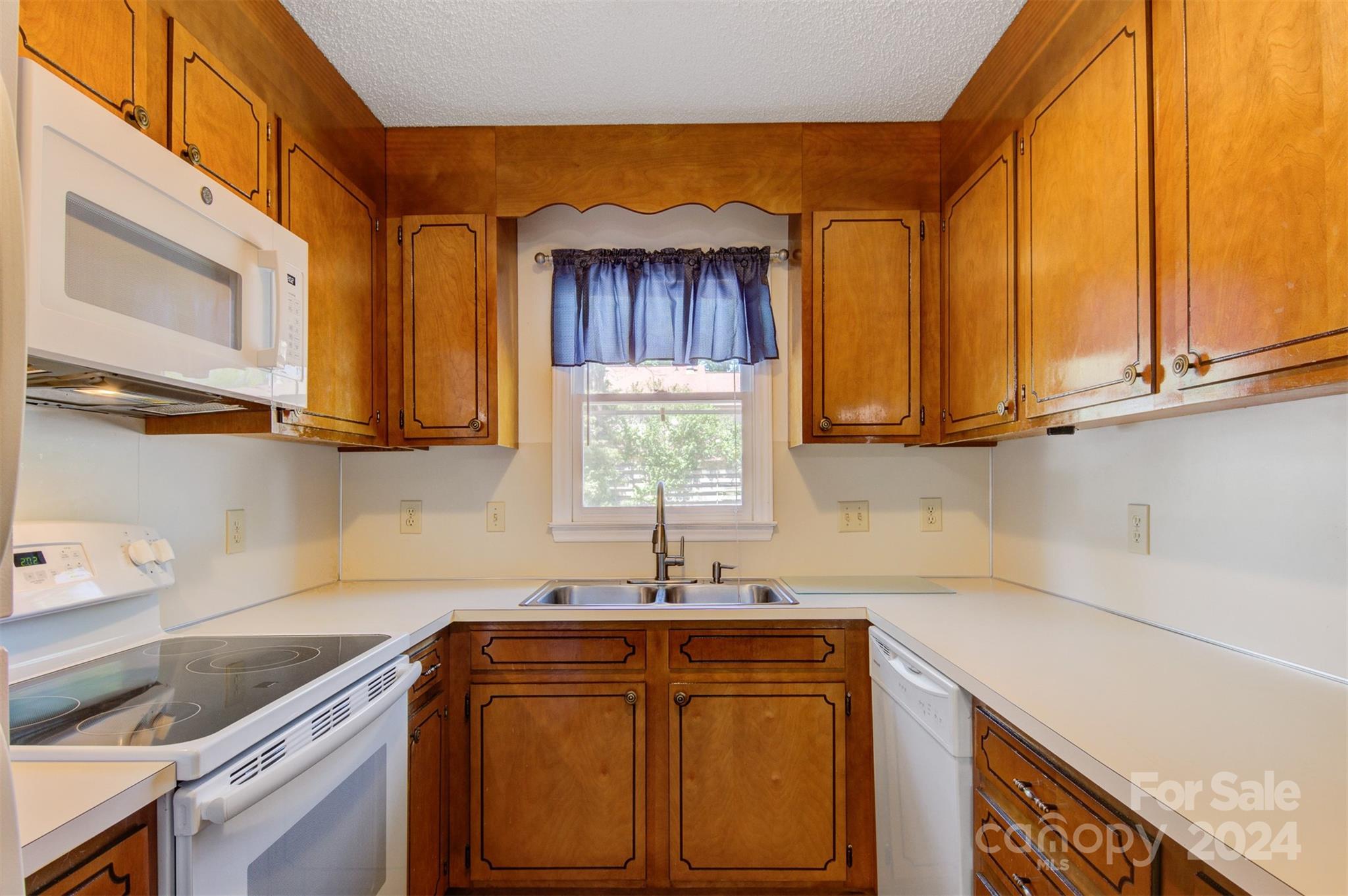 1318 5th Street Northeast Hickory, NC 28601 - Photo 15 of 27 a kitchen with stainless steel appliances granite countertop a sink a stove and cabinets