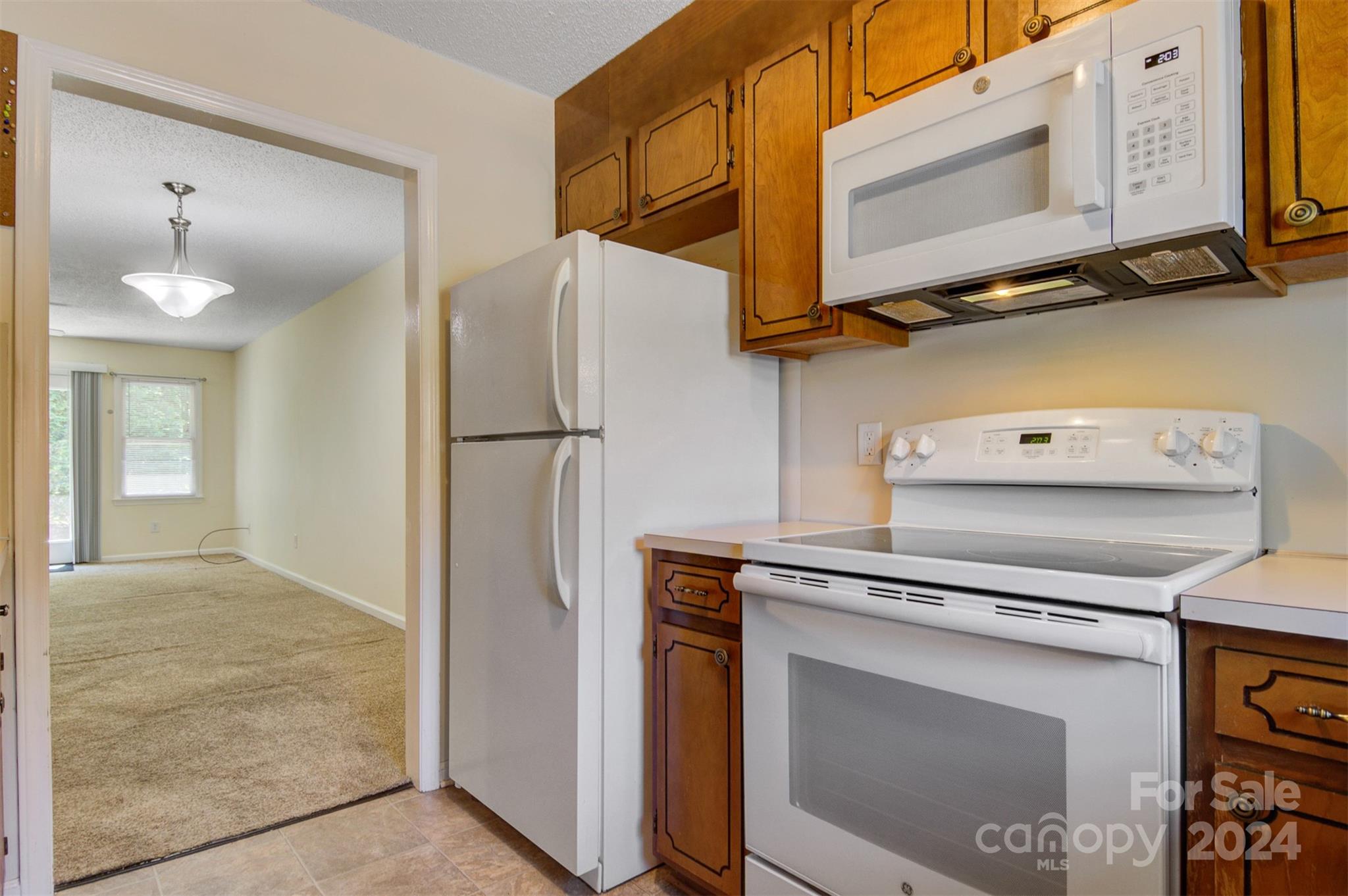 1318 5th Street Northeast Hickory, NC 28601 - Photo 17 of 27 a kitchen with a refrigerator and a stove top oven