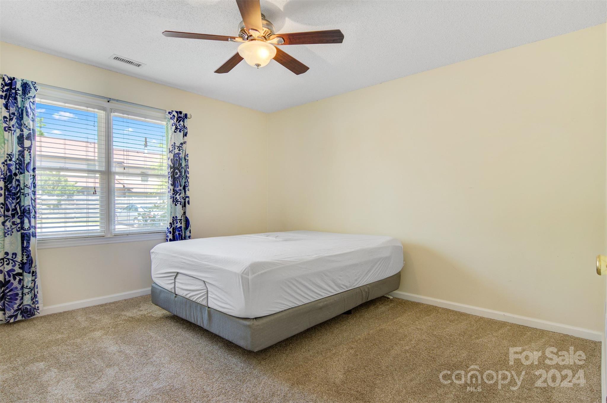 1318 5th Street Northeast Hickory, NC 28601 - Photo 18 of 27 a bed sitting in a bedroom next to a window