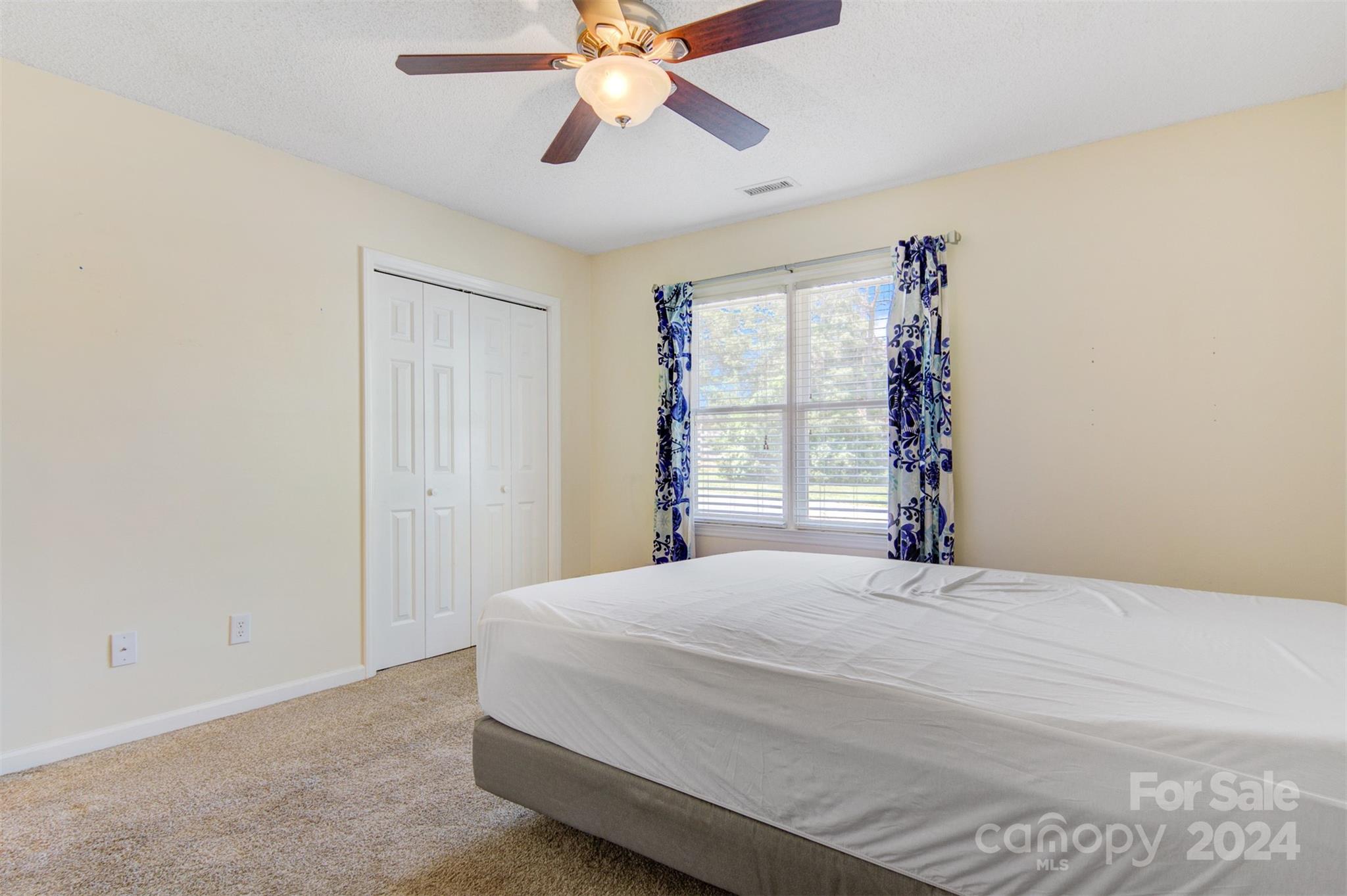 1318 5th Street Northeast Hickory, NC 28601 - Photo 19 of 27 a bedroom with a bed and a chandelier