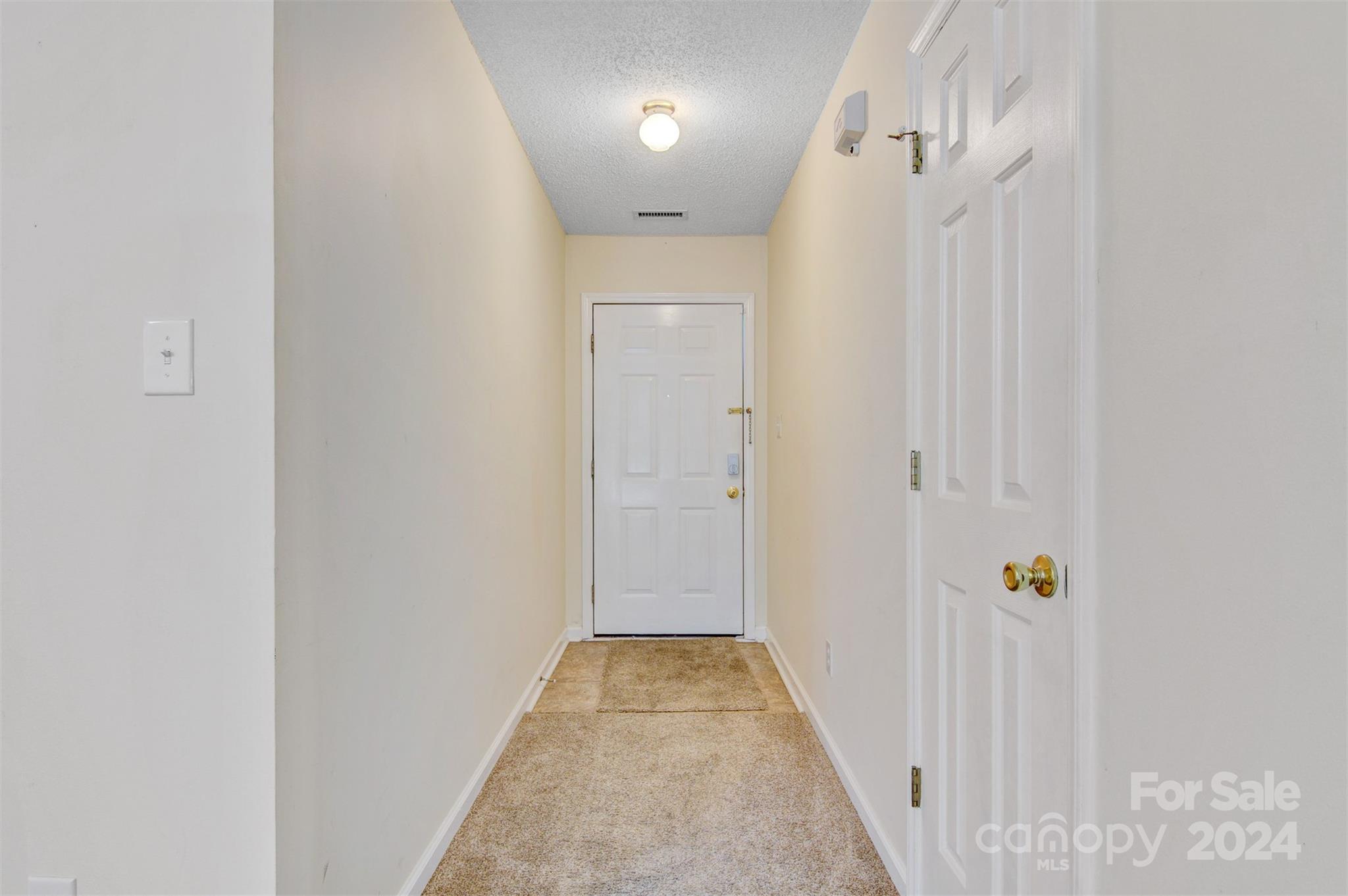 1318 5th Street Northeast Hickory, NC 28601 - Photo 3 of 27 a view of a hallway with wooden floor and staircase