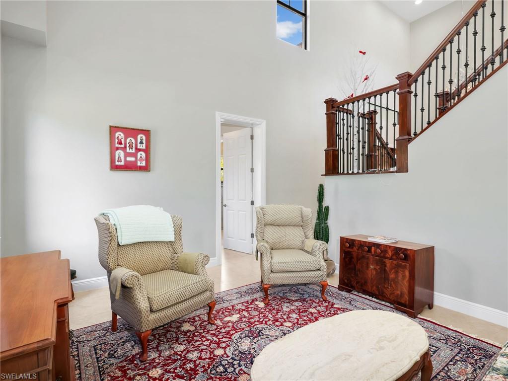 3160 27th Avenue Southwest Naples, FL 34117 - Photo 21 of 43 a living room with furniture a rug and a rug
