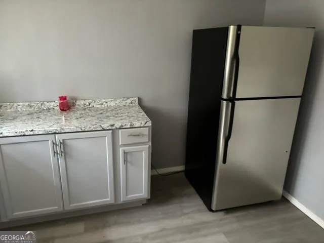 a kitchen with stainless steel appliances granite countertop a refrigerator and a sink