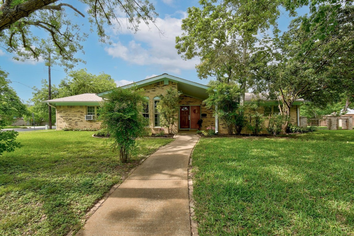 Undisclosed Address Austin, TX 78757 - Photo 1 of 1 a view of a house with a garden