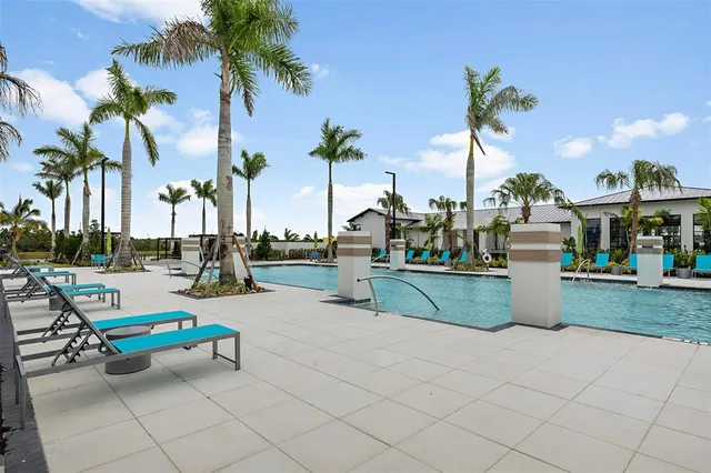 a view of swimming pool with a table and chairs