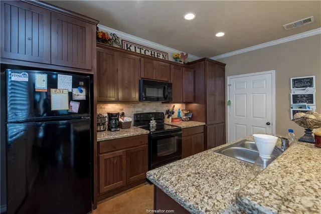 a kitchen with a refrigerator stove and sink