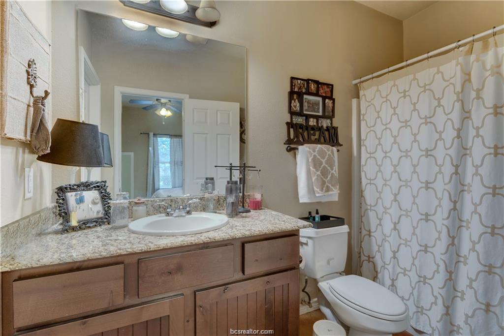 3368 Keefer Loop College Station, TX 77845 - Photo 7 of 11 a bathroom with a granite countertop sink mirror vanity and toilet