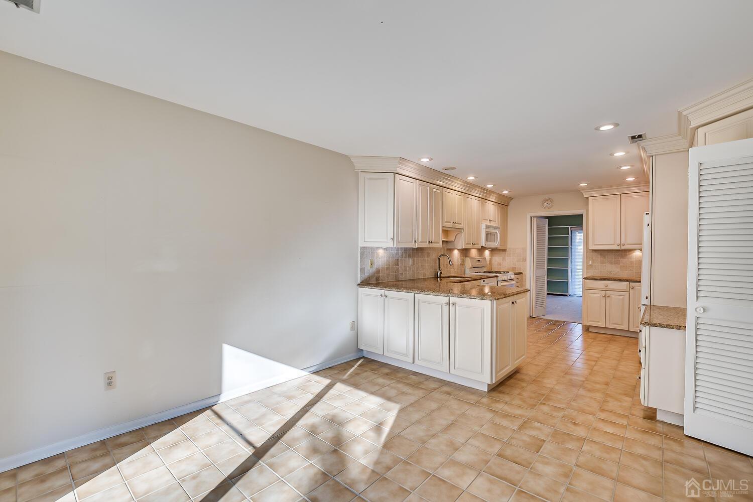 96 Heather Court Edison, NJ 08820 - Photo 11 of 37 a kitchen with stainless steel appliances granite countertop a refrigerator and a sink