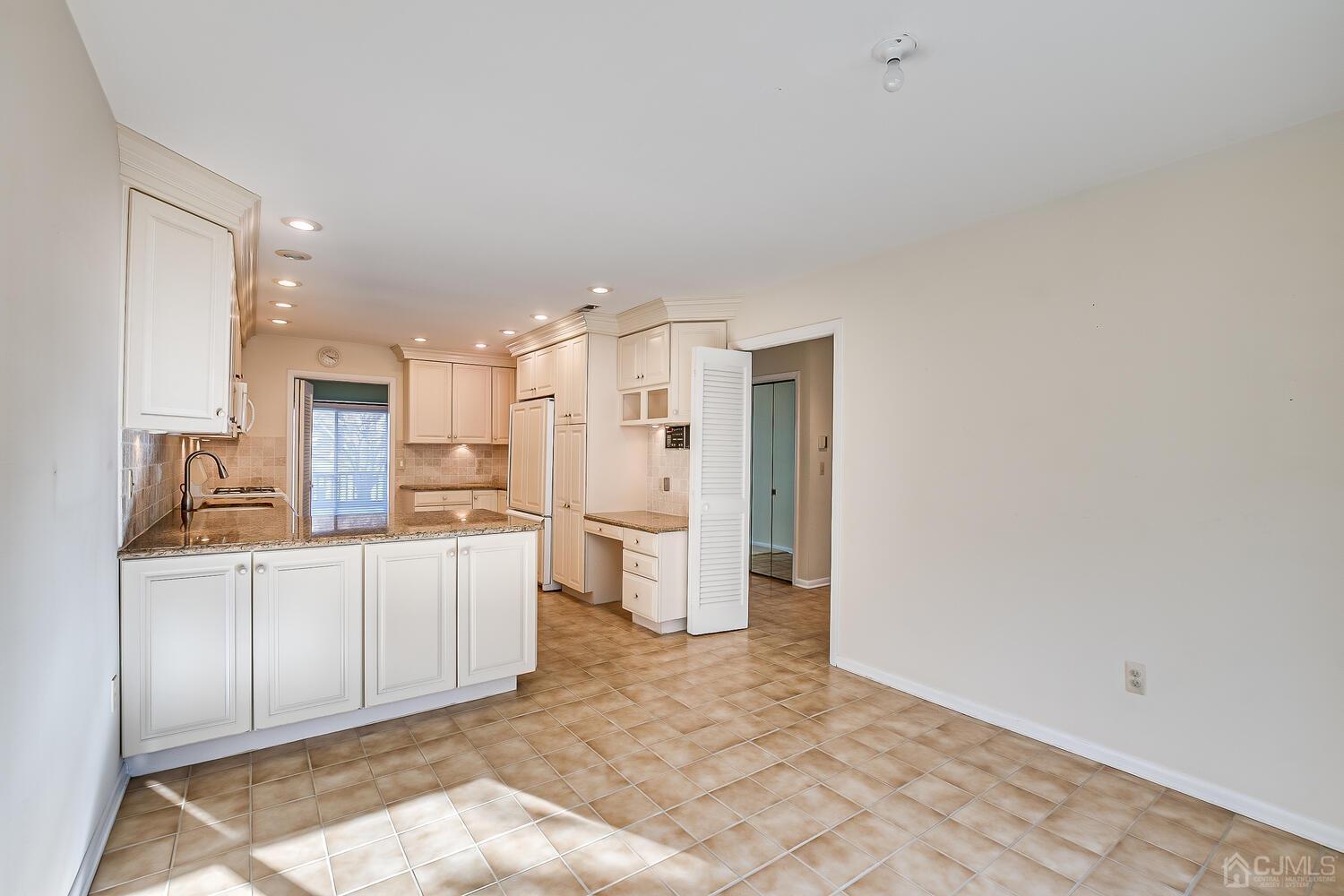 96 Heather Court Edison, NJ 08820 - Photo 12 of 37 a large white kitchen with a sink and refrigerator