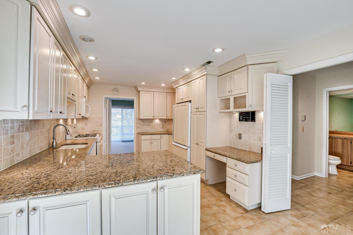 96 Heather Court Edison, NJ 08820 - Photo 13 of 37 a kitchen with stainless steel appliances granite countertop refrigerator sink and cabinets
