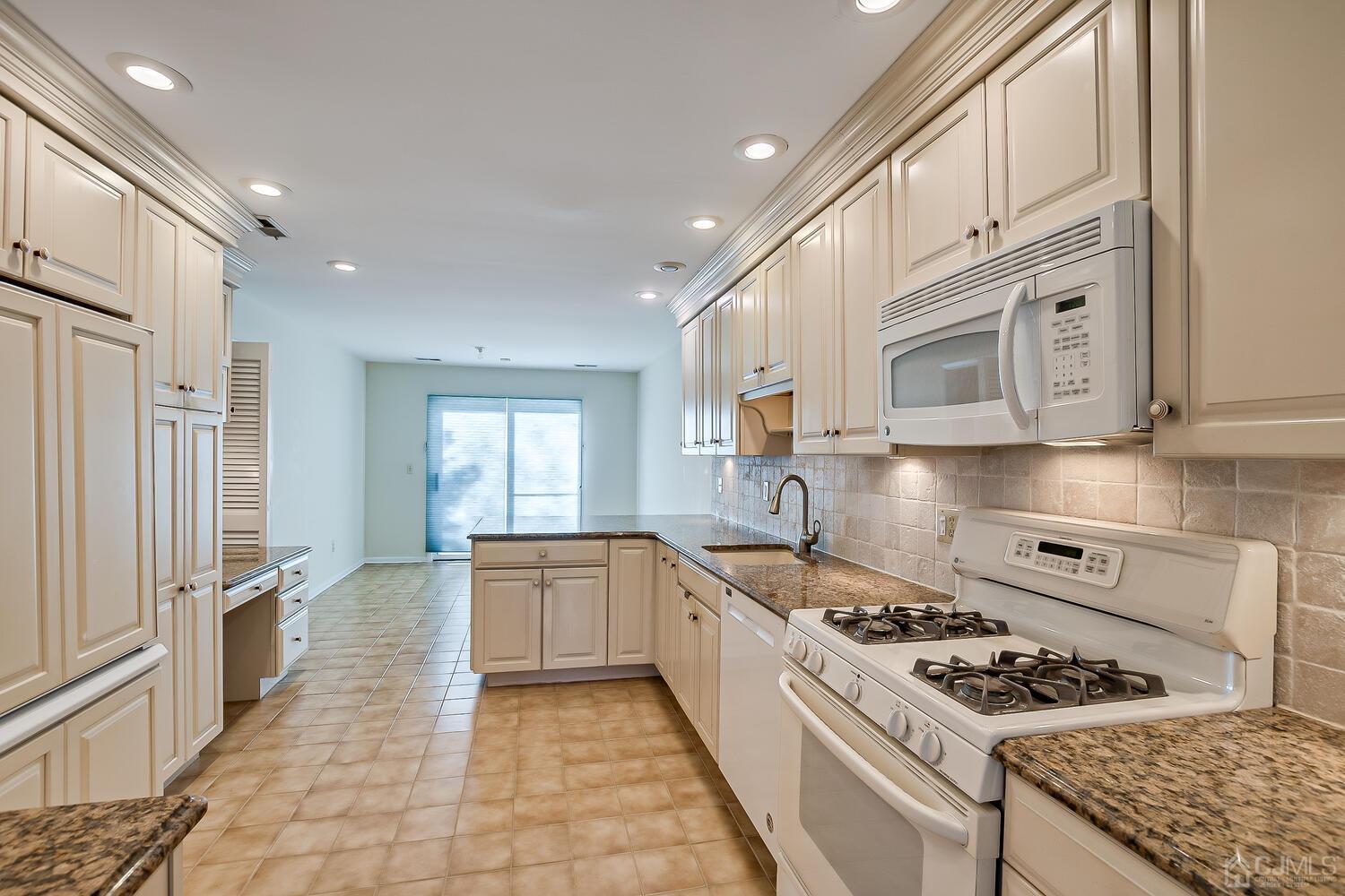 96 Heather Court Edison, NJ 08820 - Photo 15 of 37 a kitchen with stainless steel appliances granite countertop a stove and a sink