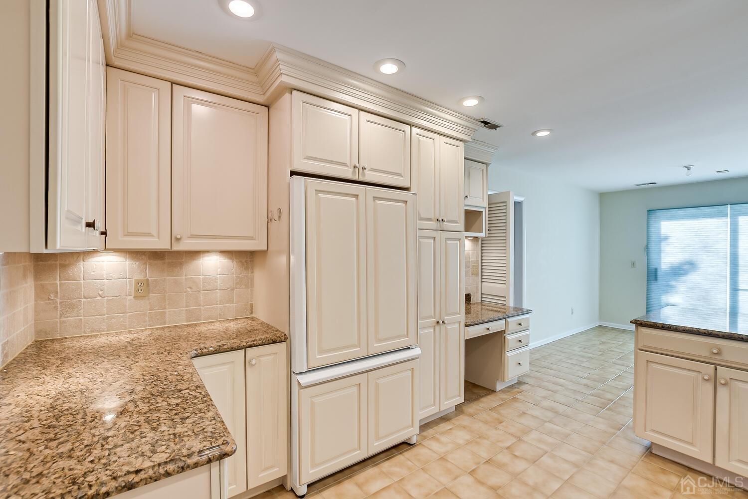 96 Heather Court Edison, NJ 08820 - Photo 16 of 37 a kitchen with white cabinets and refrigerator