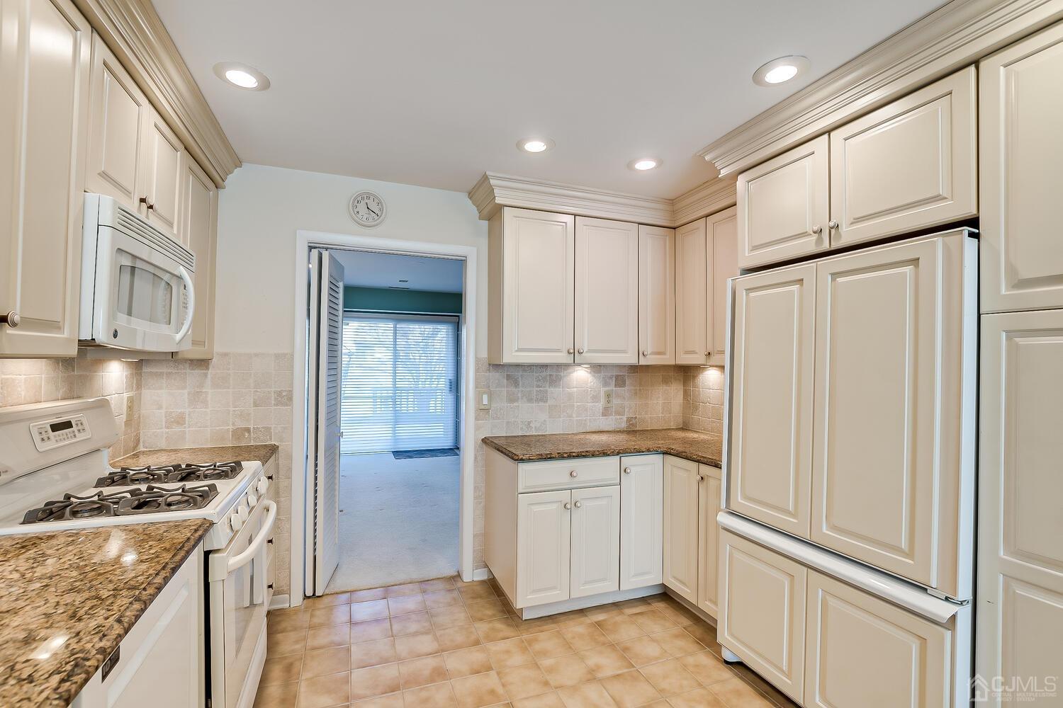 96 Heather Court Edison, NJ 08820 - Photo 17 of 37 a kitchen with white cabinets and appliances