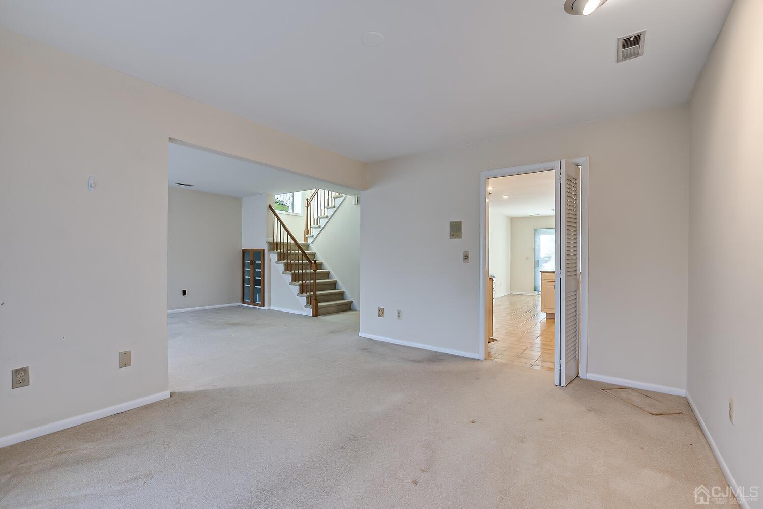 96 Heather Court Edison, NJ 08820 - Photo 19 of 37 an empty room with staircase and white walls