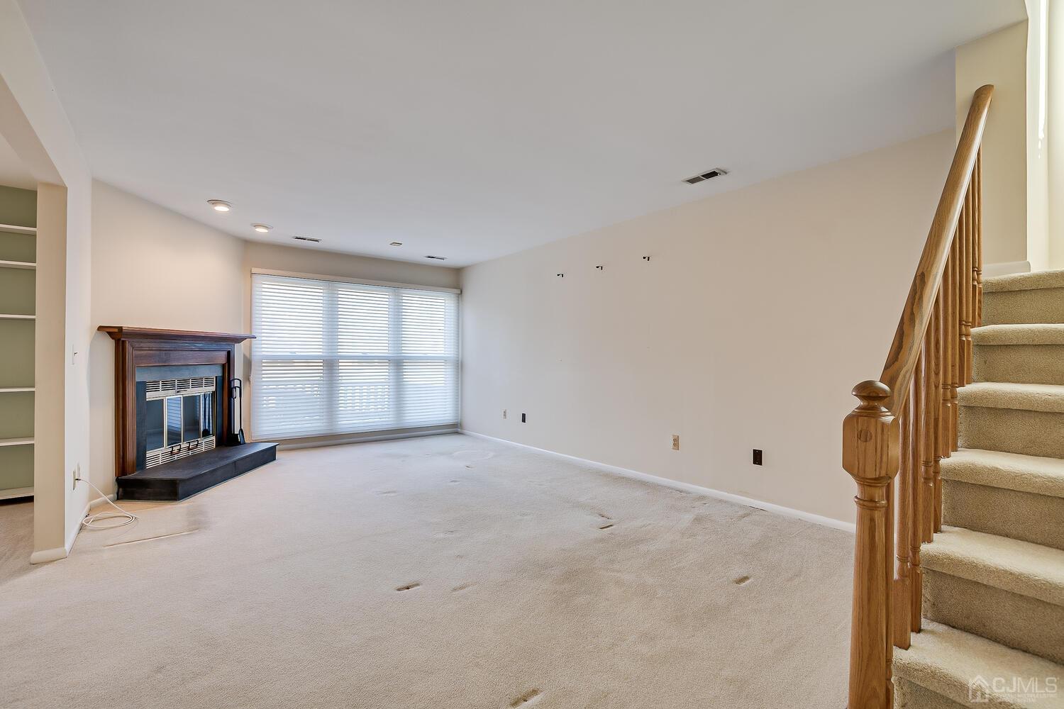 96 Heather Court Edison, NJ 08820 - Photo 20 of 37 a view of an empty room with a fireplace