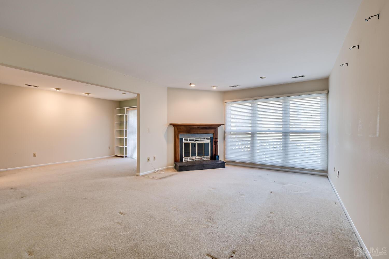 96 Heather Court Edison, NJ 08820 - Photo 21 of 37 a view of an empty room with a fireplace and a window