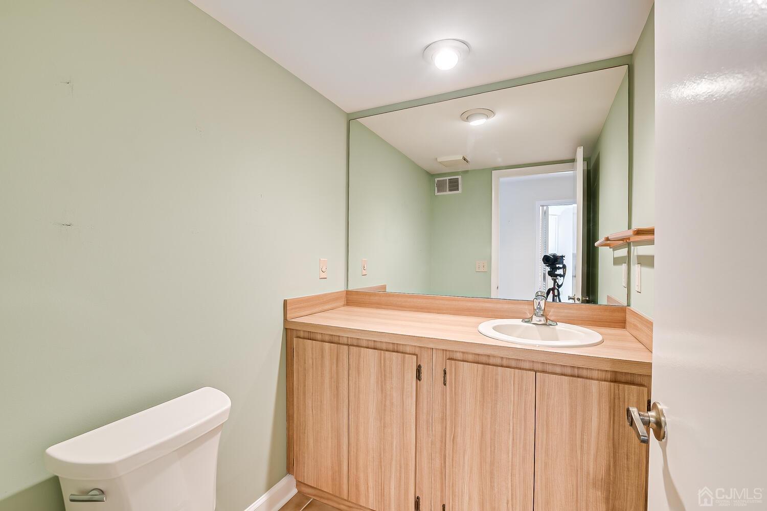 96 Heather Court Edison, NJ 08820 - Photo 23 of 37 a bathroom with a sink a toilet and mirror