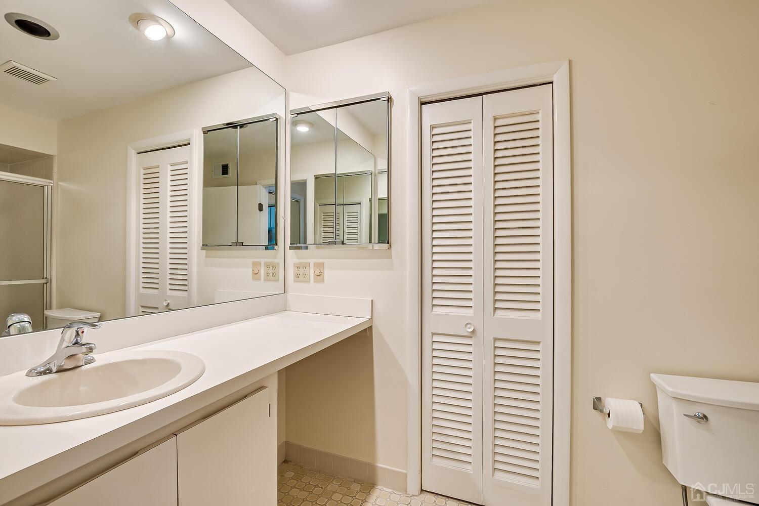 96 Heather Court Edison, NJ 08820 - Photo 28 of 37 a bathroom with a sink and a mirror
