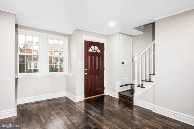 a view of an entryway with wooden floor