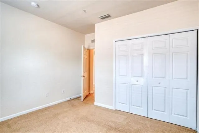 an empty room with closet area