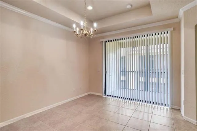 a view of kitchen with refrigerator and window