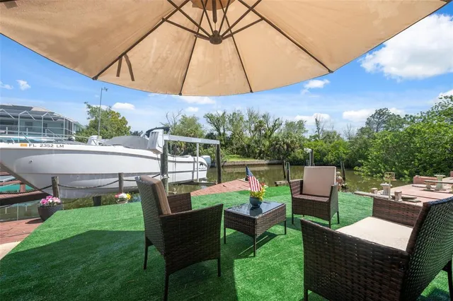 a view of an outdoor sitting area with furniture and a yard