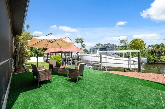 a view of a house with backyard and sitting area