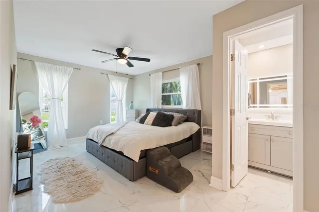 a spacious bedroom with a bed and a chandelier