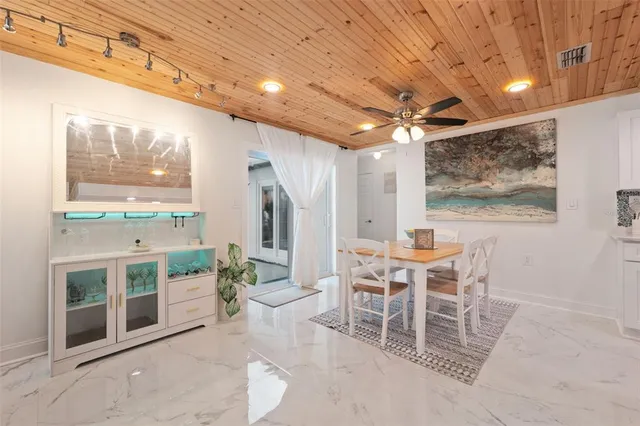 a dining room with furniture a flat screen tv and outdoor view