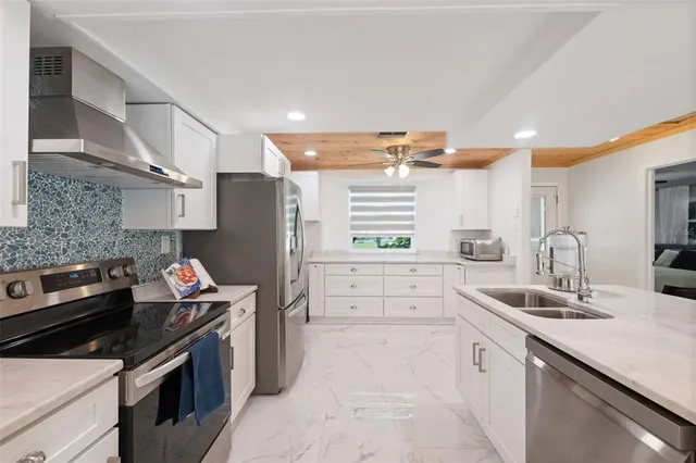 a kitchen with a sink stove and refrigerator
