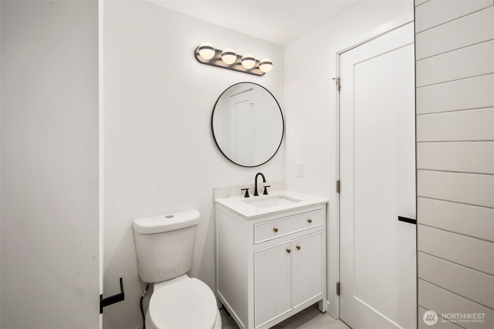 3811 Northeast 89th Street Seattle, WA 98115 - Photo 20 of 32 a bathroom with a toilet a sink and a mirror
