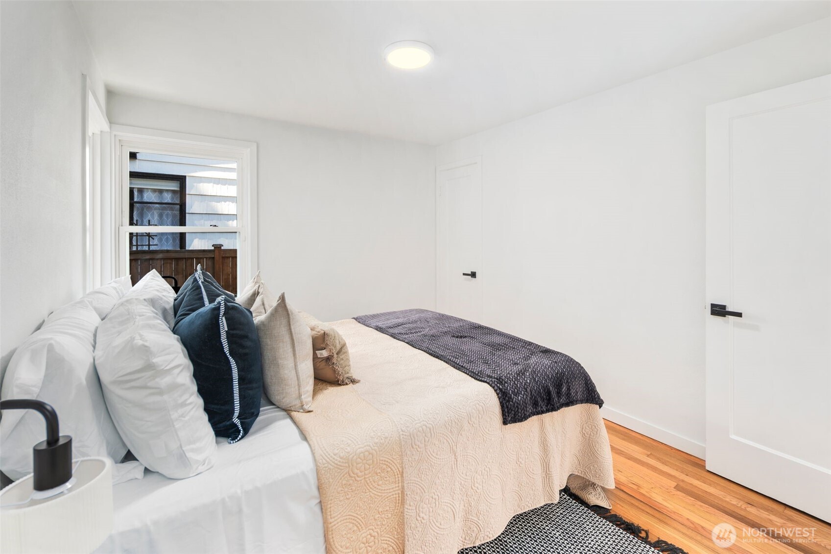 3811 Northeast 89th Street Seattle, WA 98115 - Photo 23 of 32 a bedroom with a bed and a window