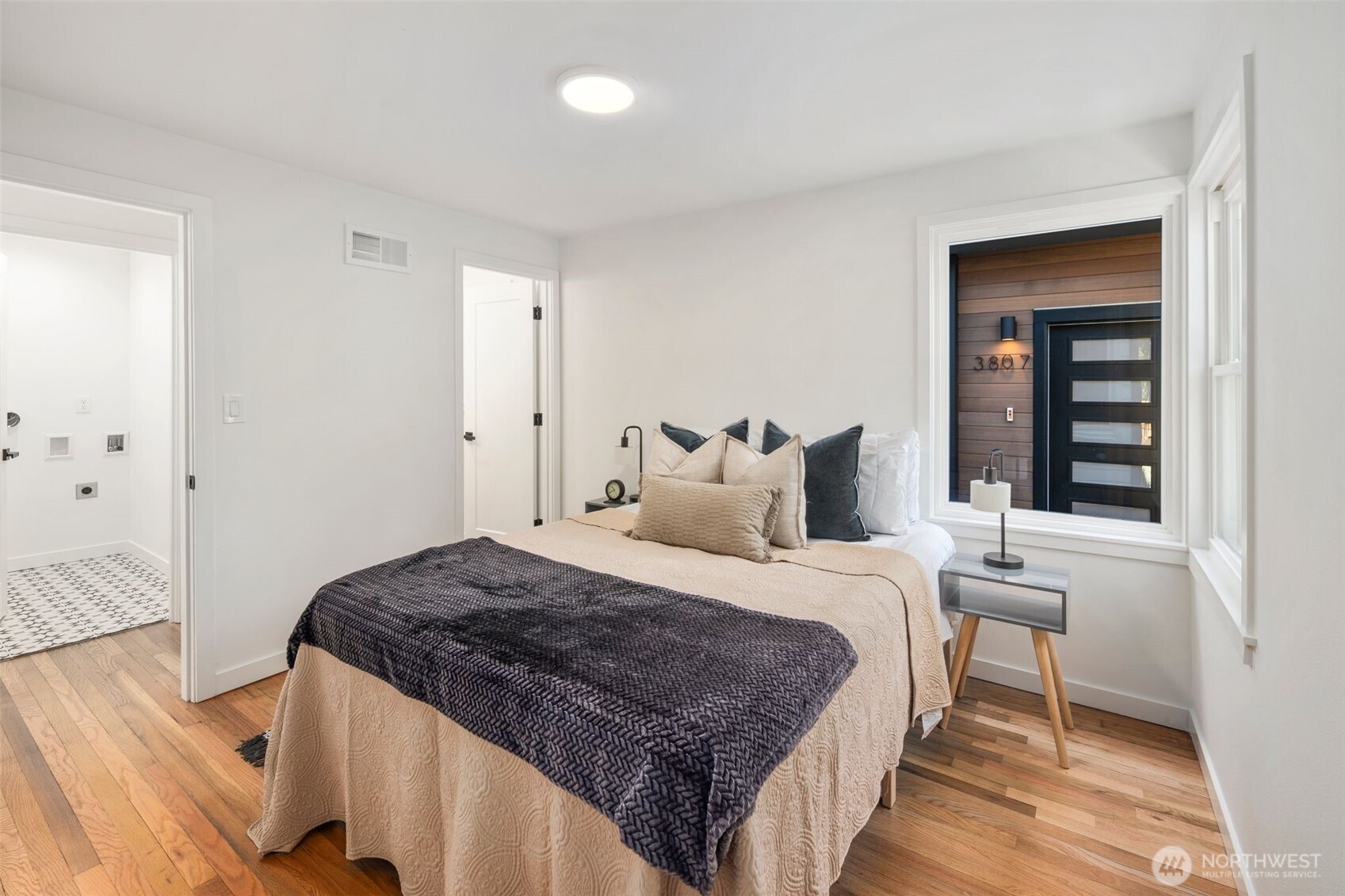3811 Northeast 89th Street Seattle, WA 98115 - Photo 25 of 32 a bedroom with a bed and wooden floor