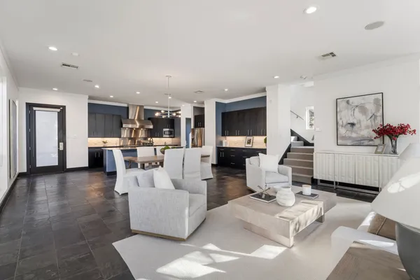 a living room with furniture and view of kitchen