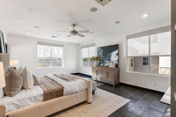 a spacious bedroom with a large bed and a window