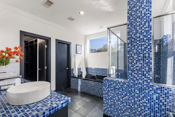 a bathroom with a sink mirror and shower