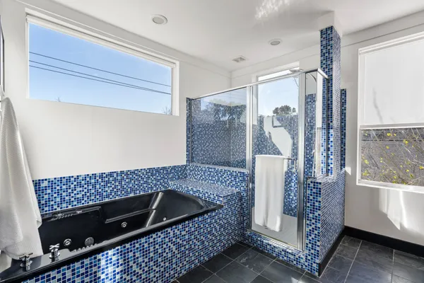a bathroom with a bathtub and shower