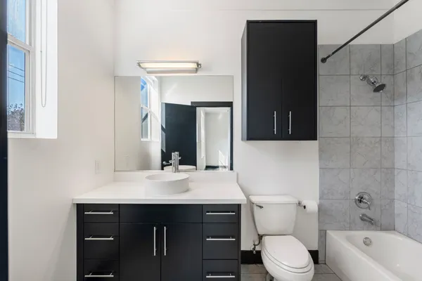 a bathroom with a sink a toilet and bathtub