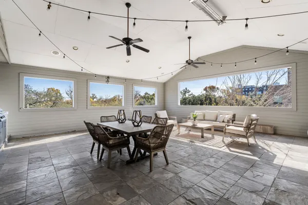 a living room with lots of furniture and a chandelier