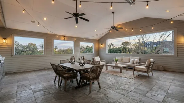 a dining room with furniture a large window and a rug