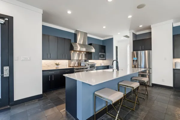 a large kitchen with a table and chairs